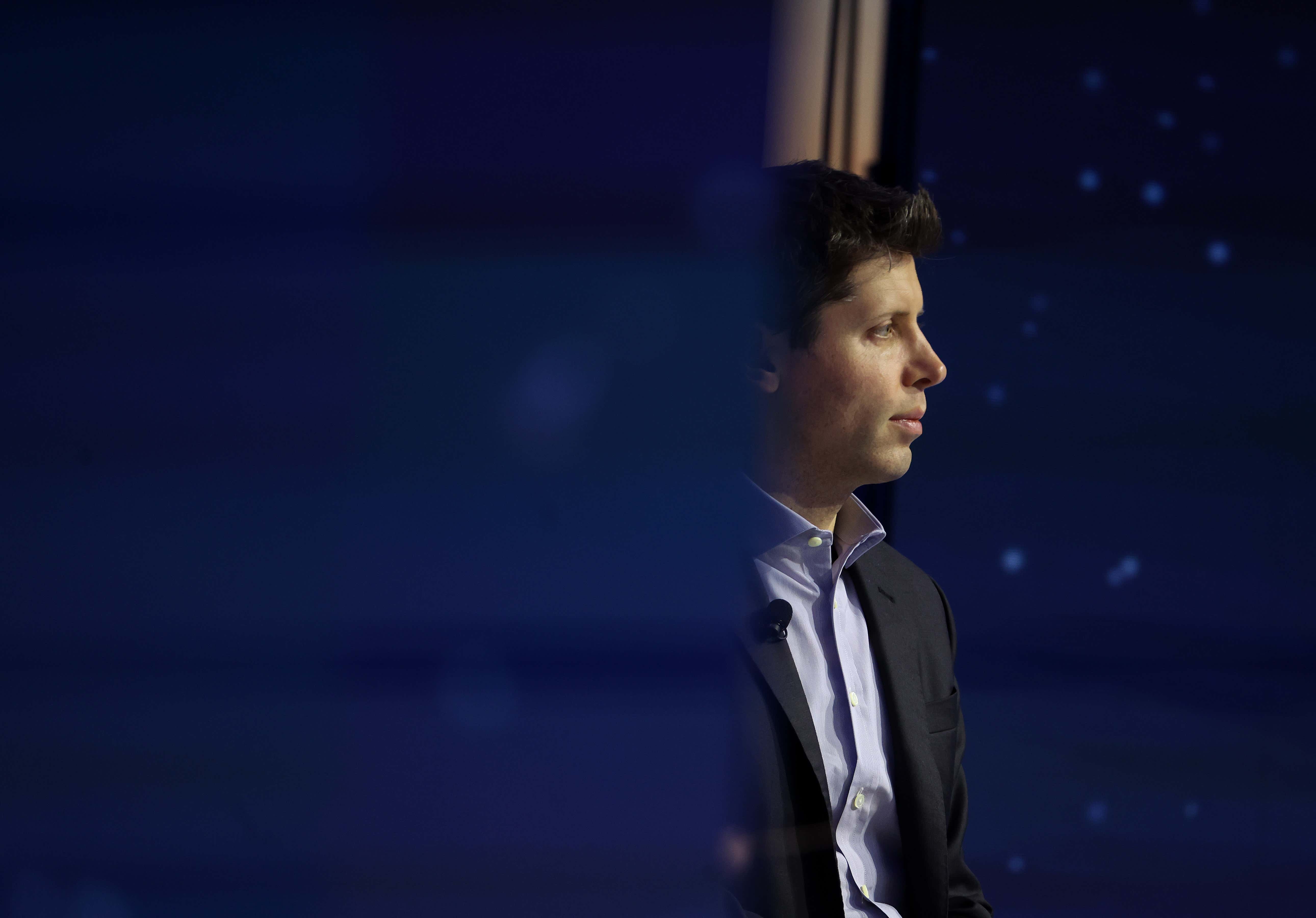 Photo of right side of Sam Altman as he looks out into the crowd